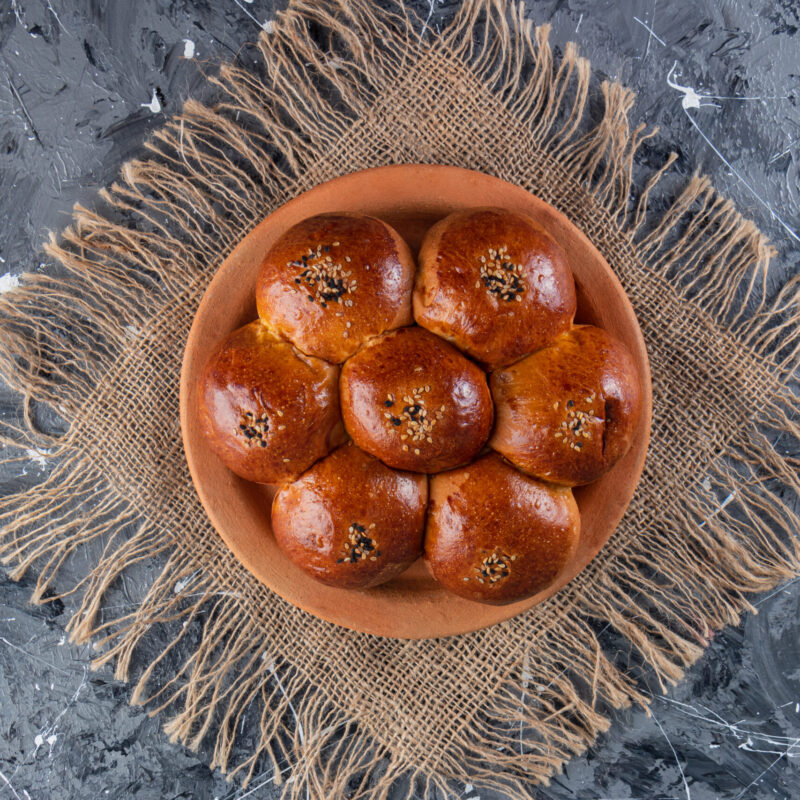 Bun chamomile with poppy seeds placed on a clay plate