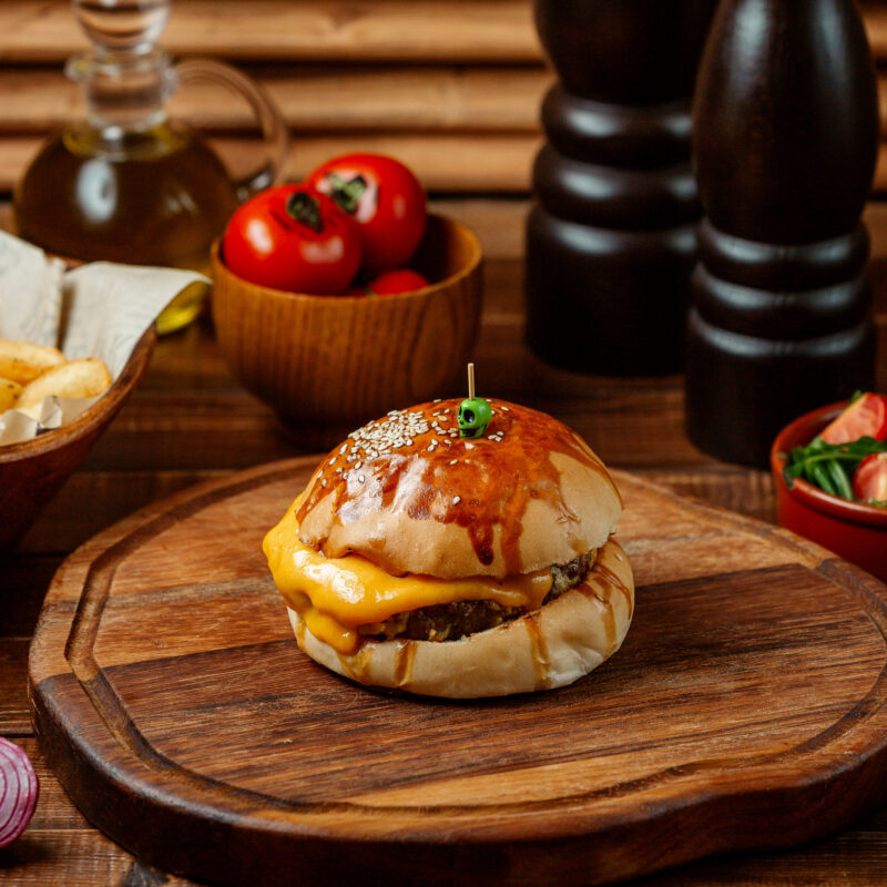 classic cheeseburger on wooden board