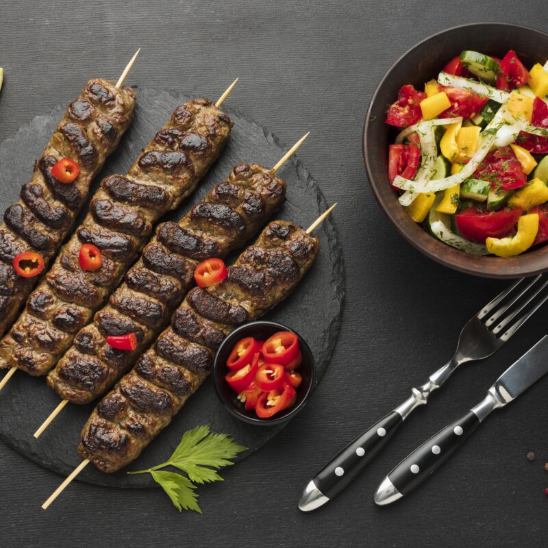 flat-lay-tasty-kebab-slate-with-other-dish-cutlery