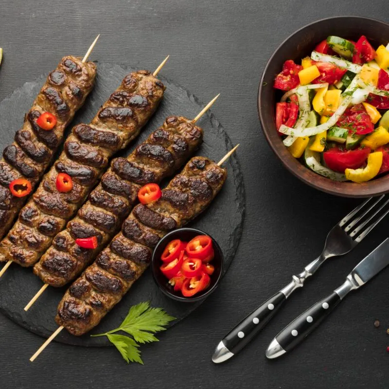 flat-lay-tasty-kebab-slate-with-other-dish-cutlery-scaled-300x300