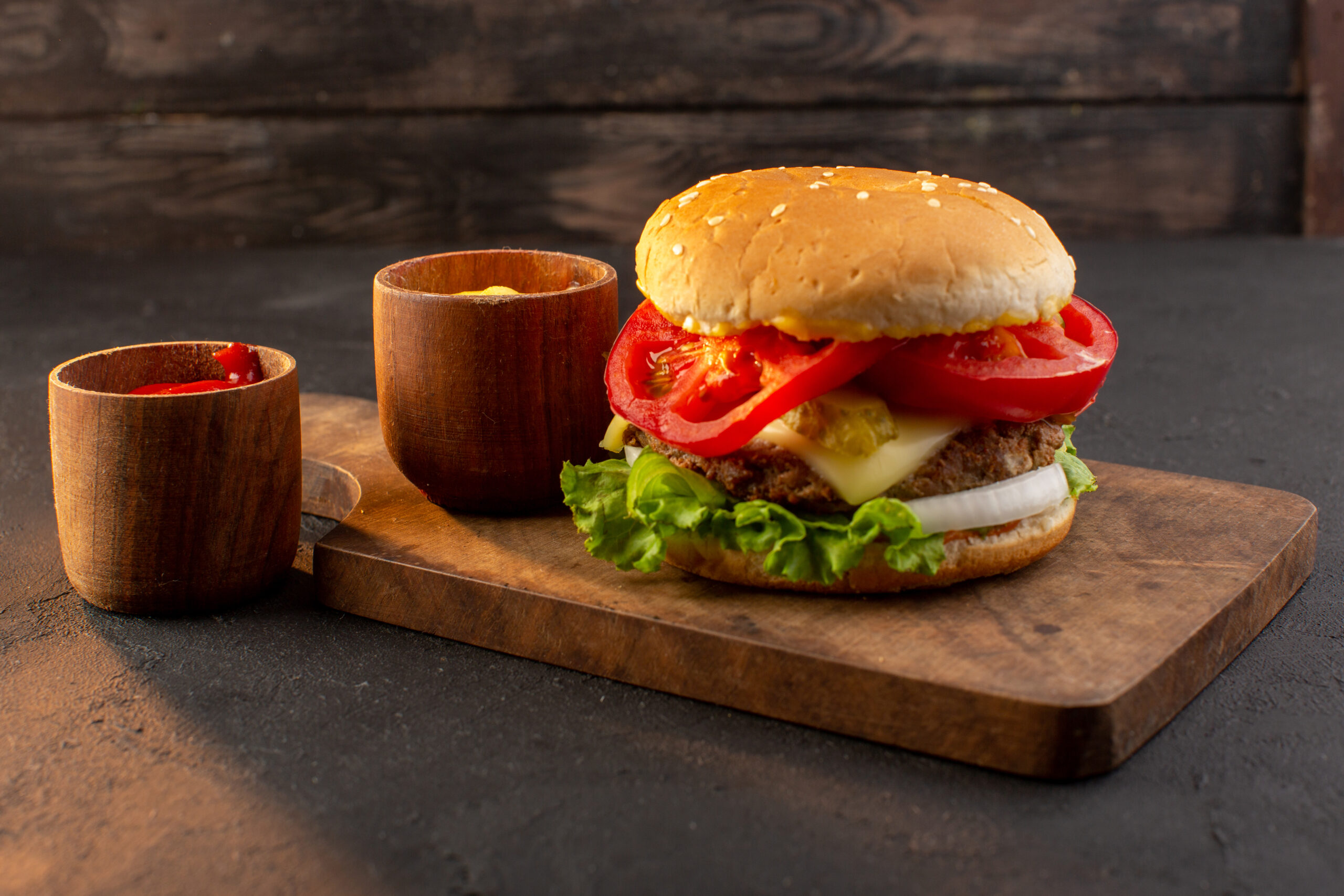 front-view-chicken-burger-with-cheese-green-salad-wooden-desk-sandwich-fast-food-meal