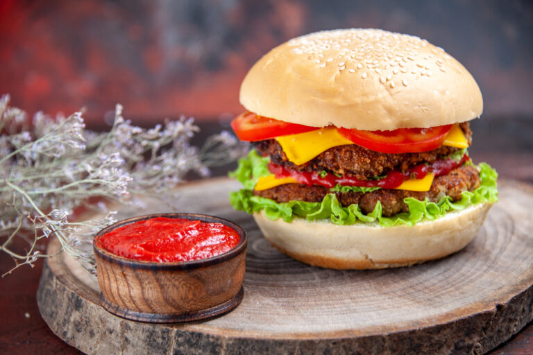 front-view-meat-burger-with-cheese-tomatoes-salad-dark-floor