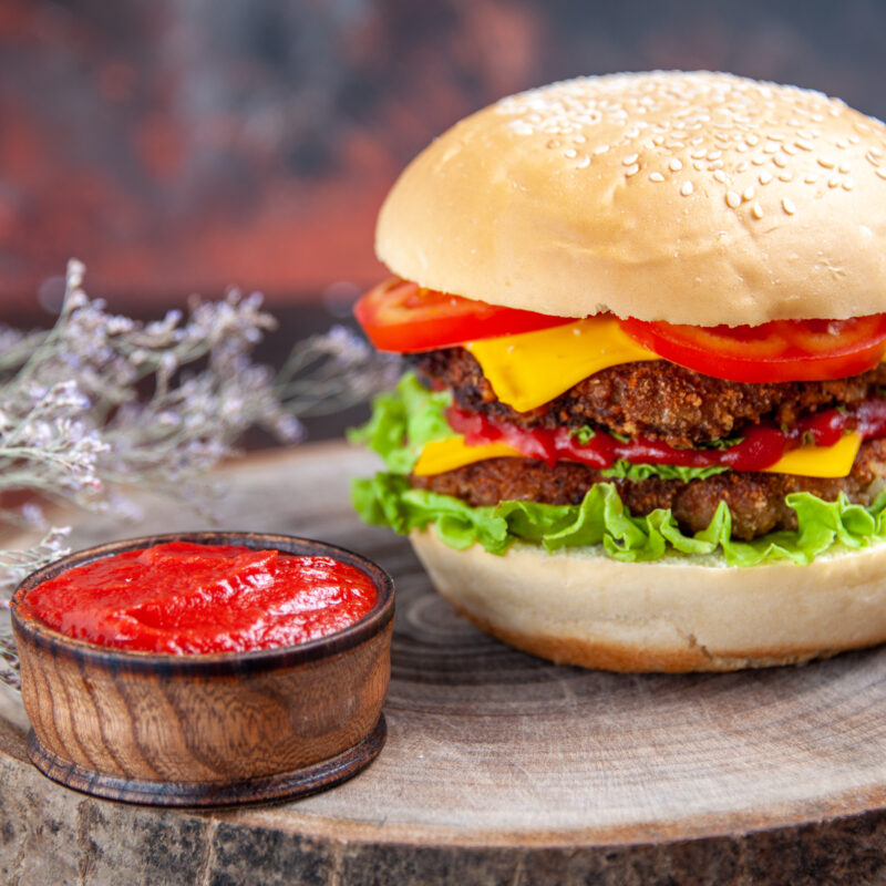 front-view-meat-burger-with-cheese-tomatoes-salad-dark-floor