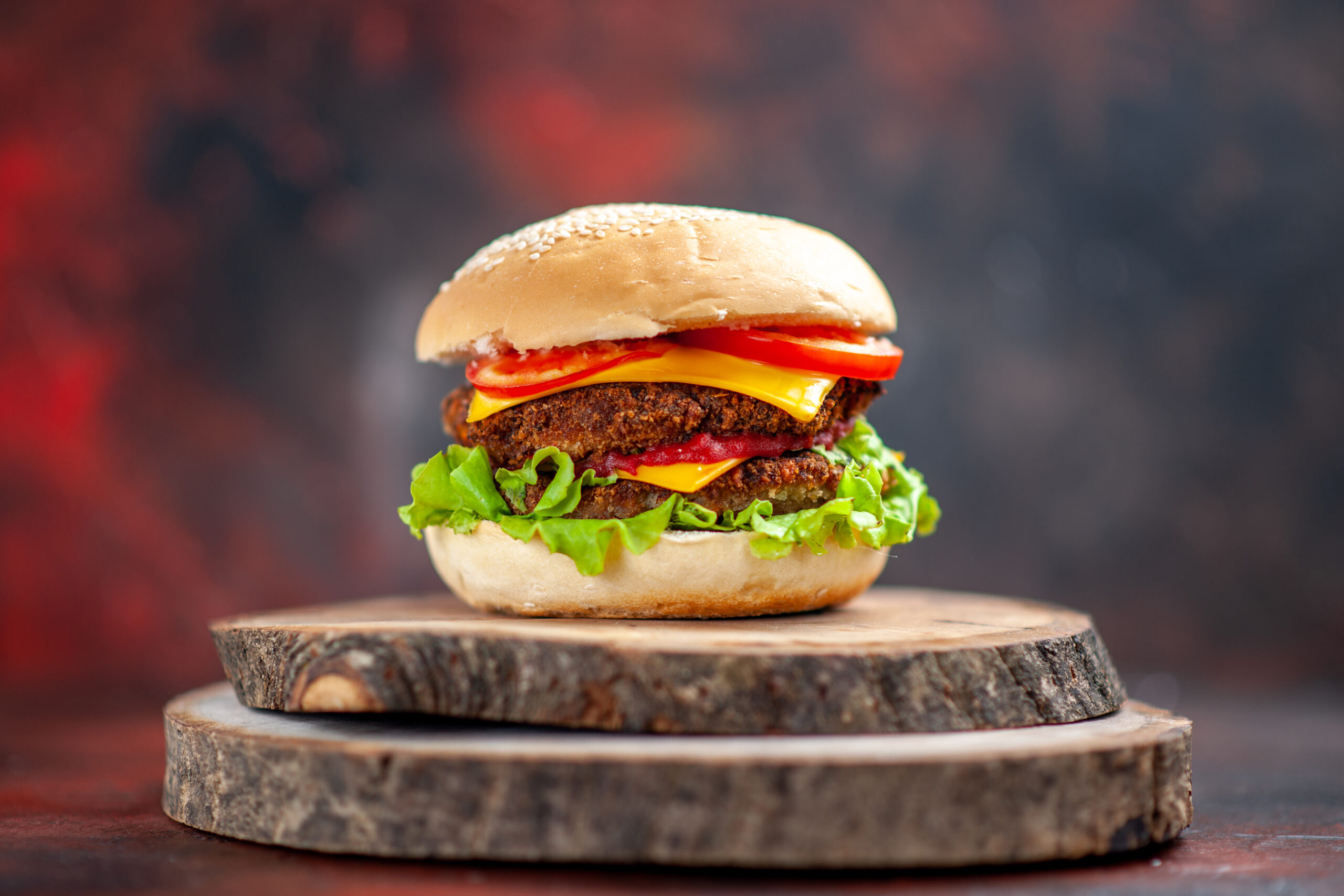 front-view-meat-burger-with-salad-cheese-tomatoes-dark-background