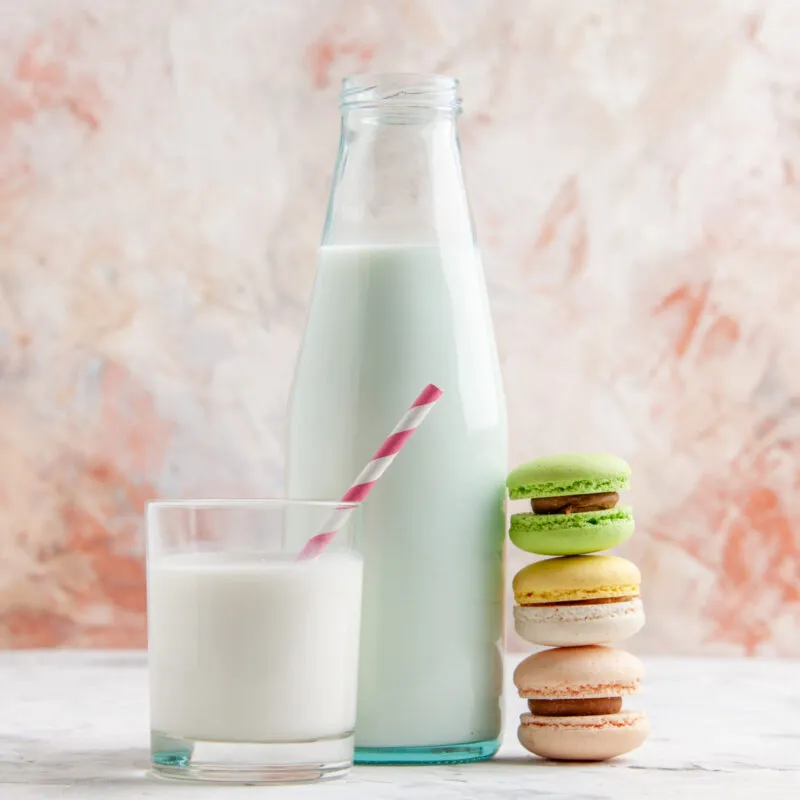 horizontal-view-fresh-milk-open-bottle-glass-cup-colorful-delicious-macarons-pastel-colors-surface-scaled-300x300