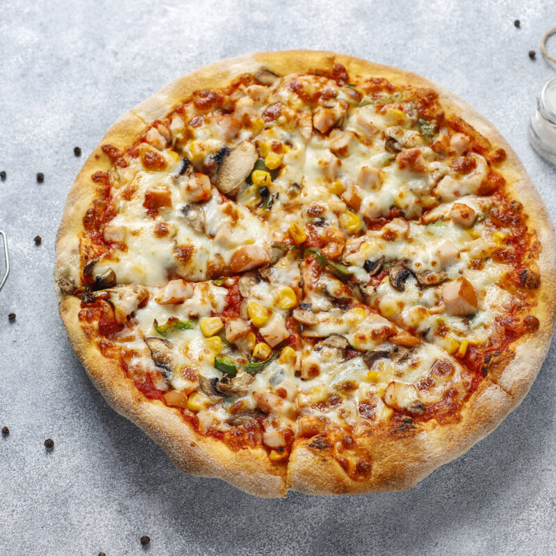 Tasty chicken pizza with mushrooms and spices