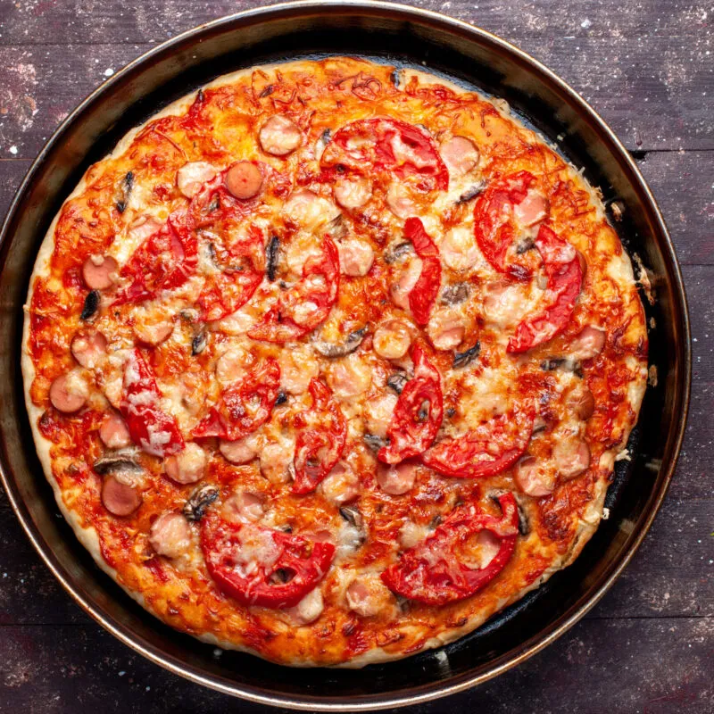 top-view-cheesy-tomato-pizza-with-olives-sausages-inside-pan-brown-desk-pizza-food-meal-fast-food-cheese-sausage-scaled-300x300 (1)