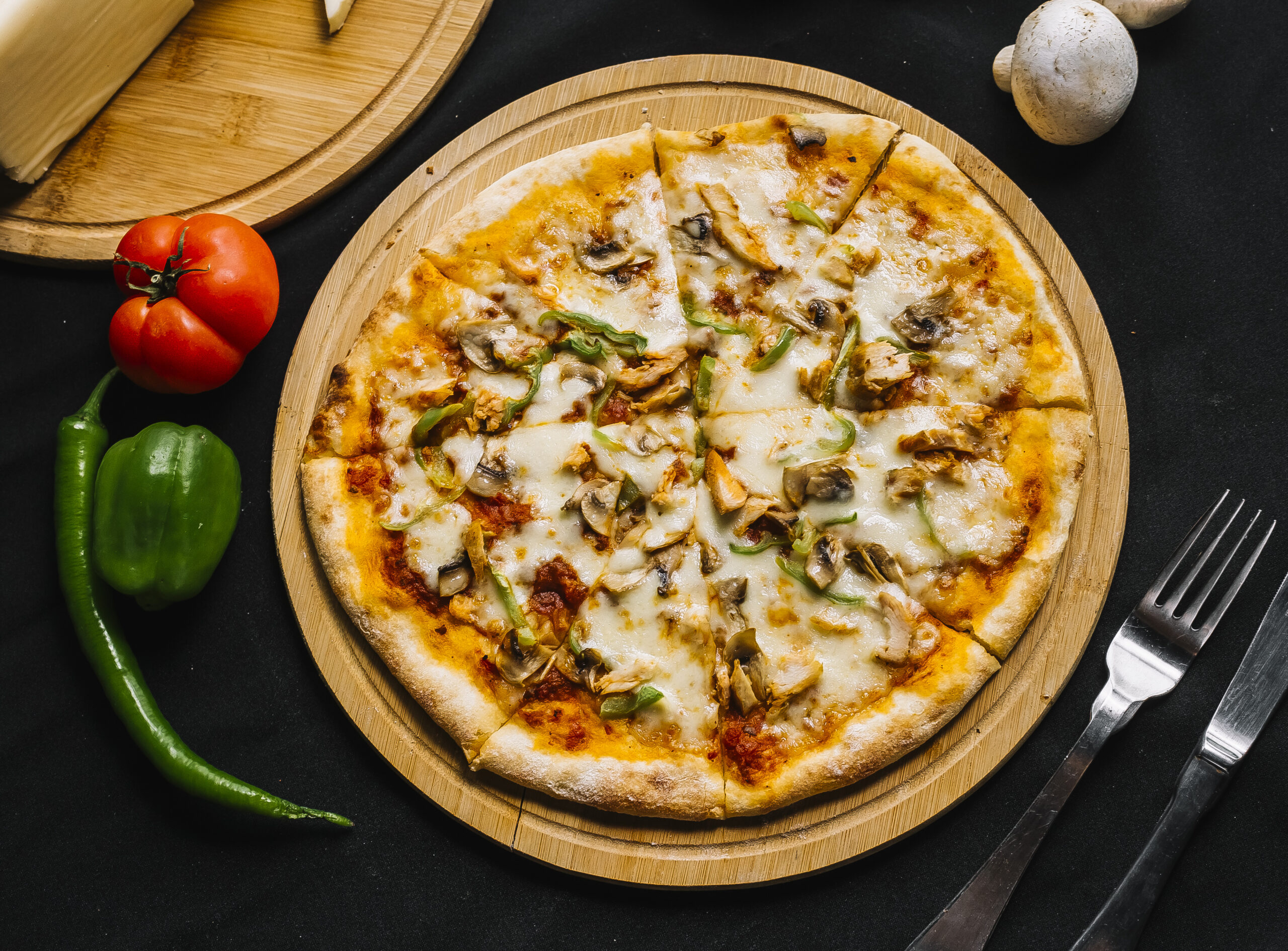 top view of chicken pizza with green bell pepper mushroom cheese and tomato sauce