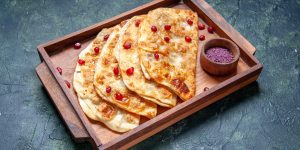 front-view-tasty-gutabs-thin-hotcakes-with-meat-inside-desk-dark-surface