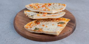 Pizza slices on a wooden board on marble background. High quality photo